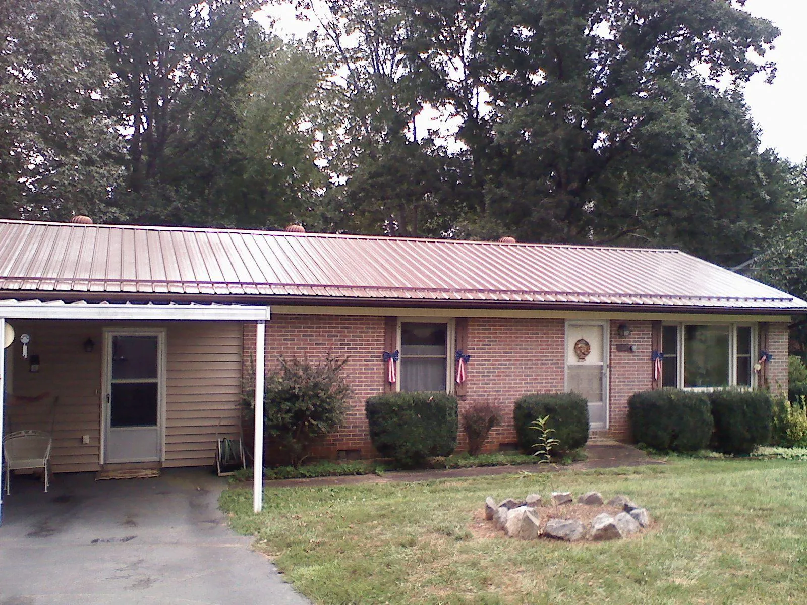 Bronze metal roof and carport on a brick ranch home — Roof Repair work by our crew in Rainier